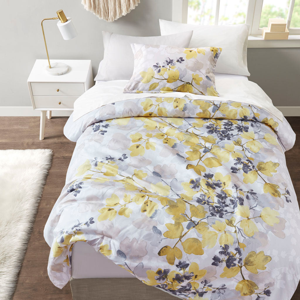 Floral comforter set with coordinating sheets and pillowcases on a bed
