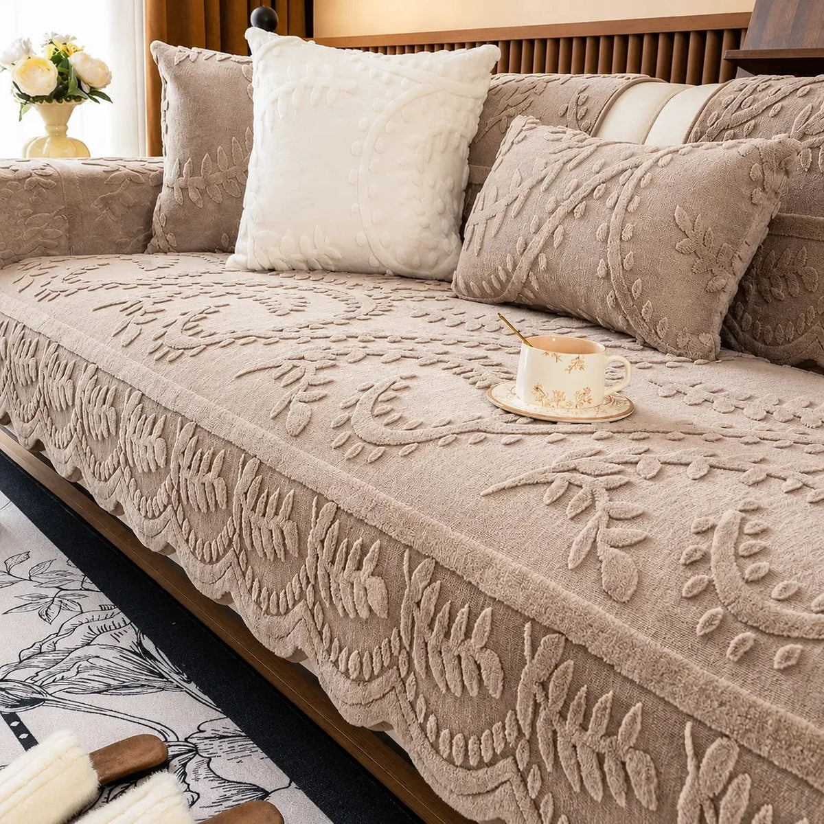 Plush sofa cover with raised botanical leaf texture and scalloped edge