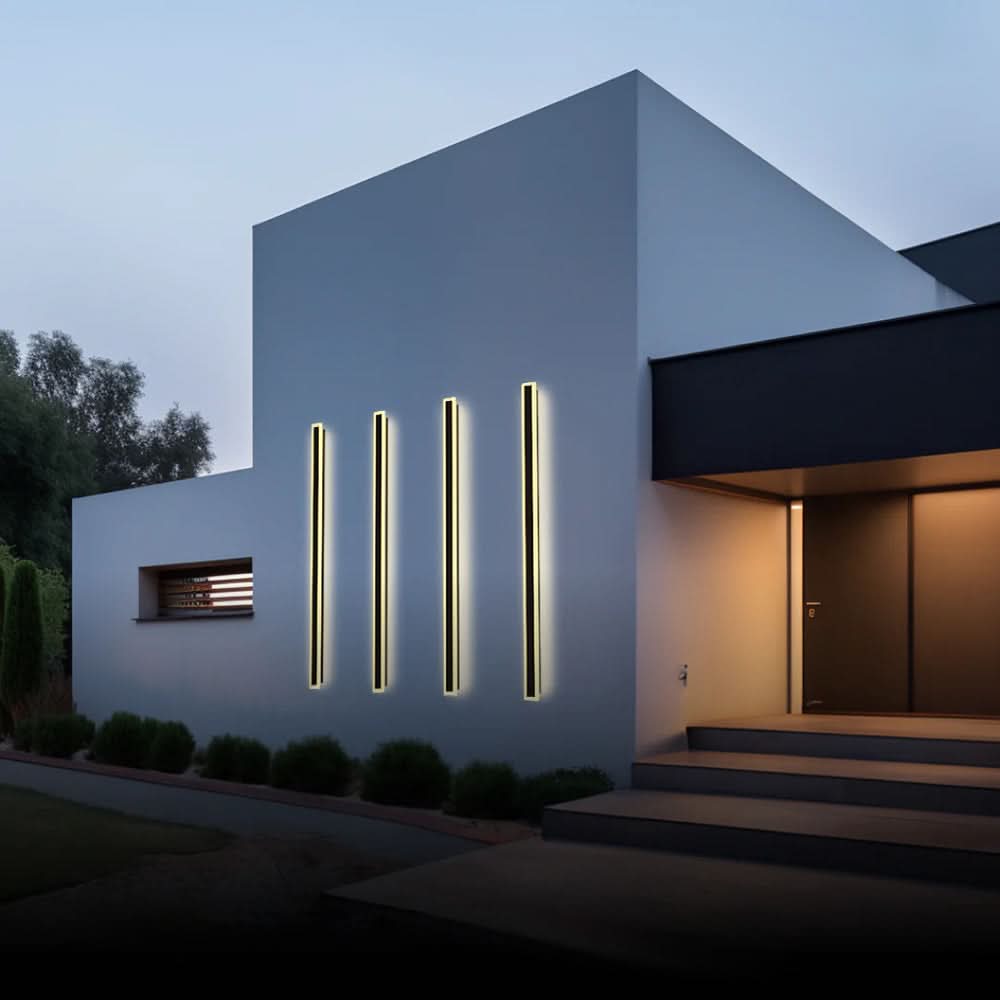 Slim black vertical outdoor wall light casting a warm glow
