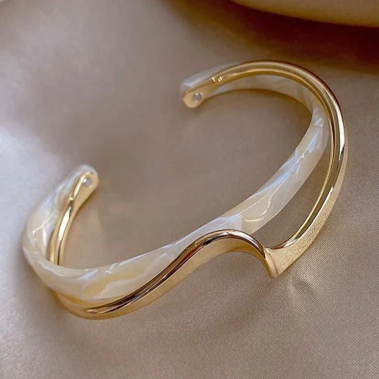 Gold-tone open cuff bracelet with curved translucent centre detail