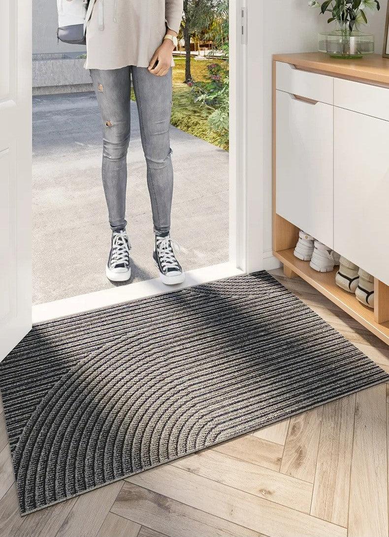 Rectangular geometric ribbed door mat on a hallway floor