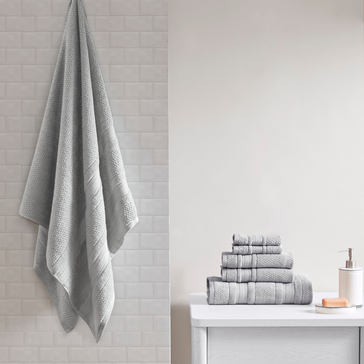 Six-piece textured bath towel set with decorative border detailing