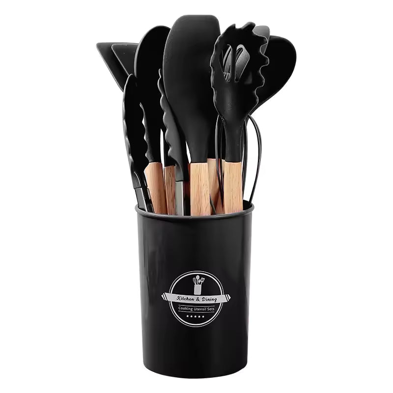 Silicone kitchen utensil set with wood-effect handles in a storage holder