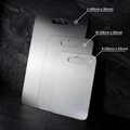 Three grey rectangular chopping boards with rounded corners and hanging holes