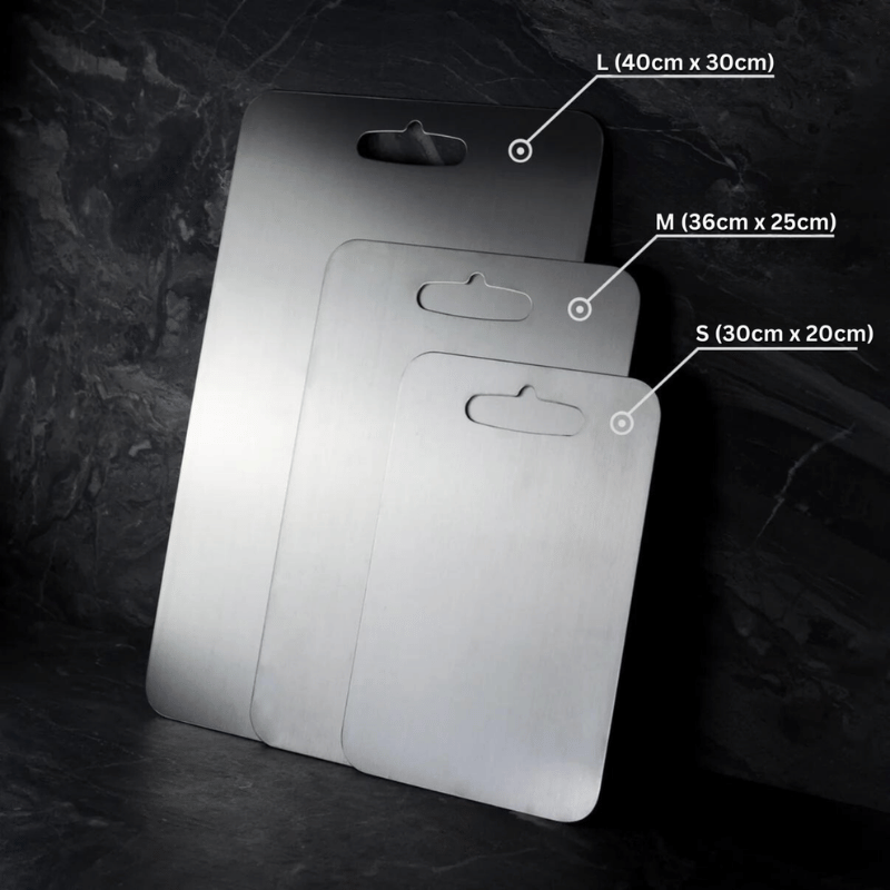 Three grey rectangular chopping boards with rounded corners and hanging holes