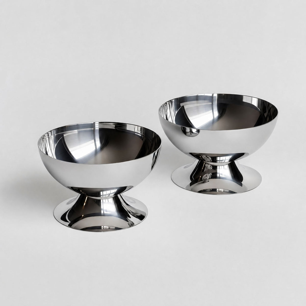 Silver stainless steel ice cream cup with a rounded bowl and pedestal base