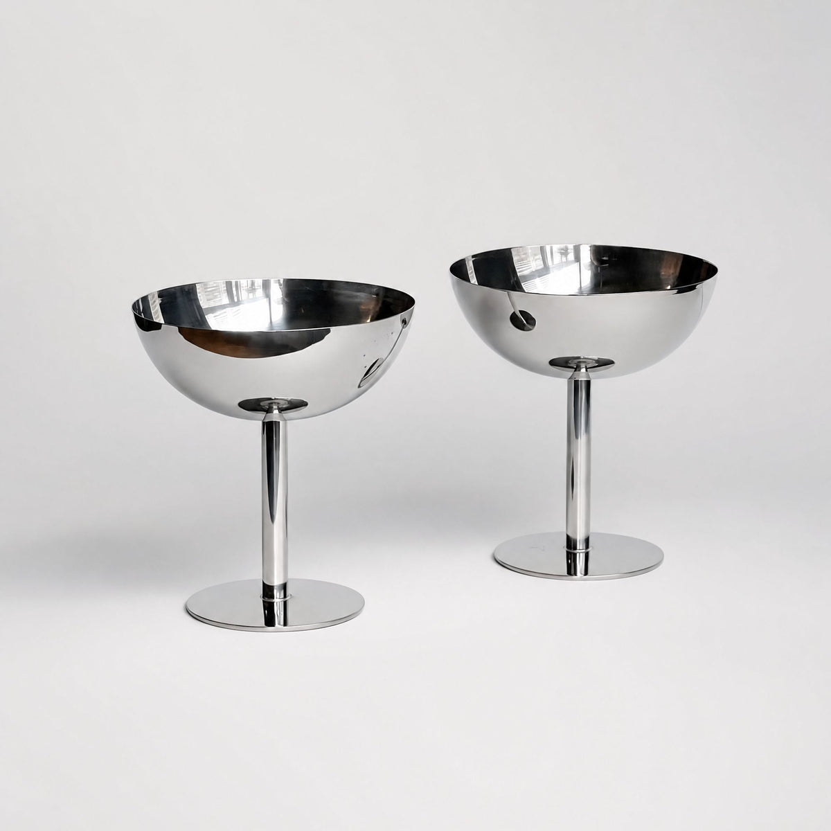 Silver stainless steel ice cream cup with a rounded bowl and pedestal base