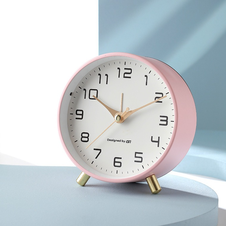 Round Scandinavian analogue table clock with numbered dial and twin feet