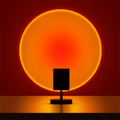 Circular glowing LED table lamp with dark stand and round base