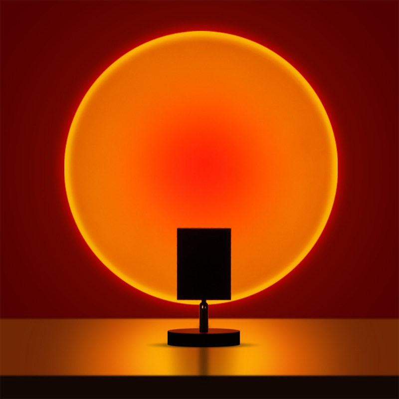 Circular glowing LED table lamp with dark stand and round base
