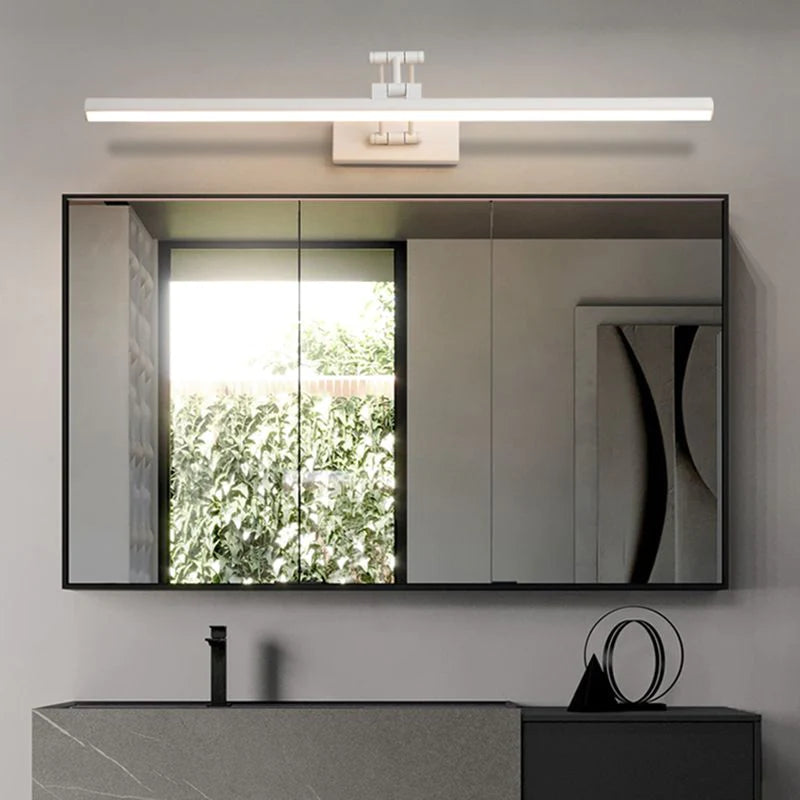 Adjustable linear wall lamp mounted above a mirror