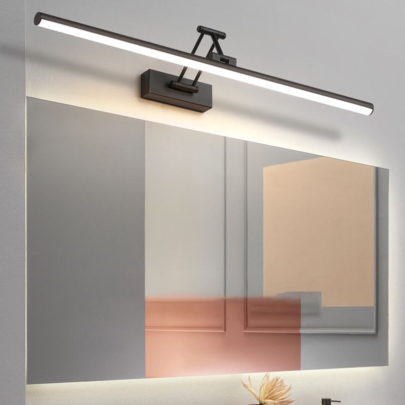 Adjustable linear wall lamp mounted above a mirror