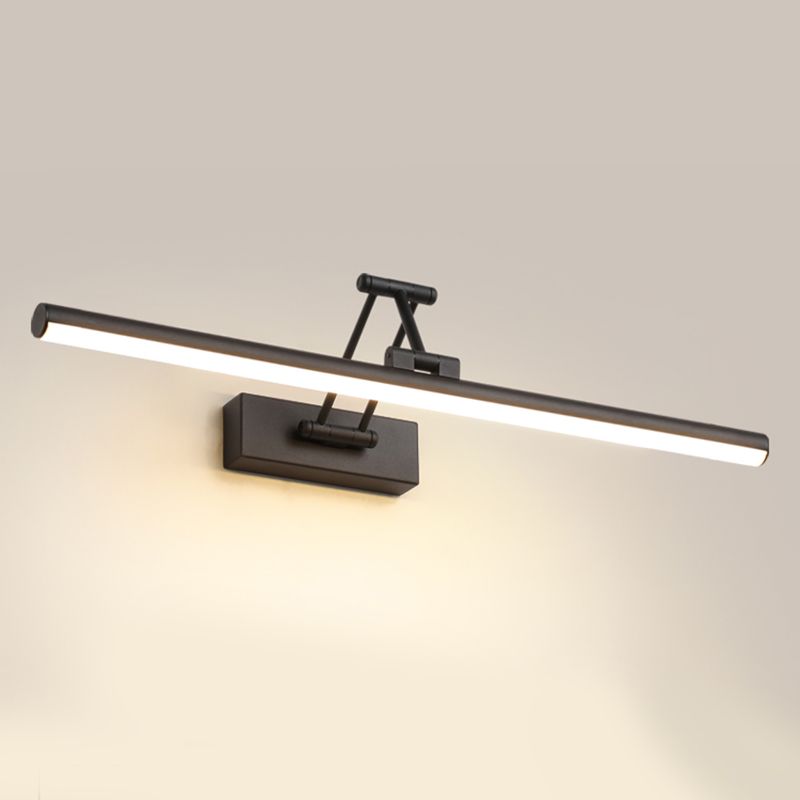 Adjustable linear wall lamp mounted above a mirror