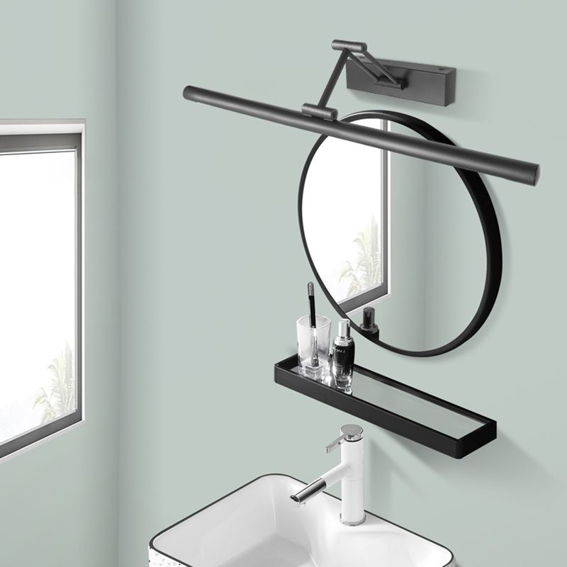 Adjustable linear wall lamp mounted above a mirror
