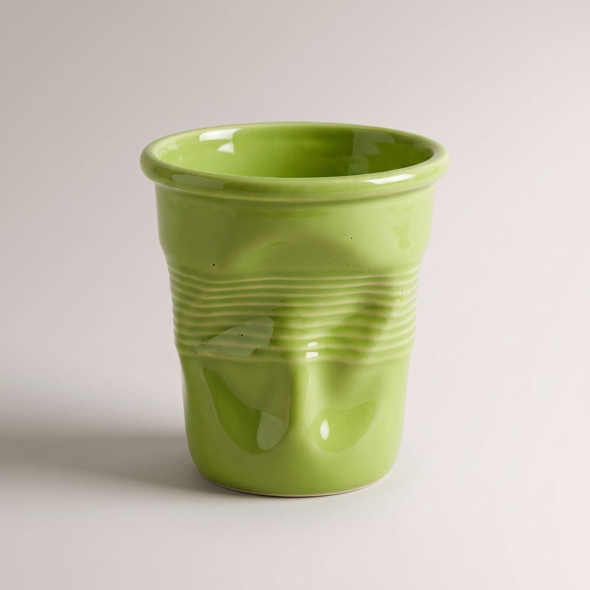 Textured ceramic mug with rounded rim and ribbed body