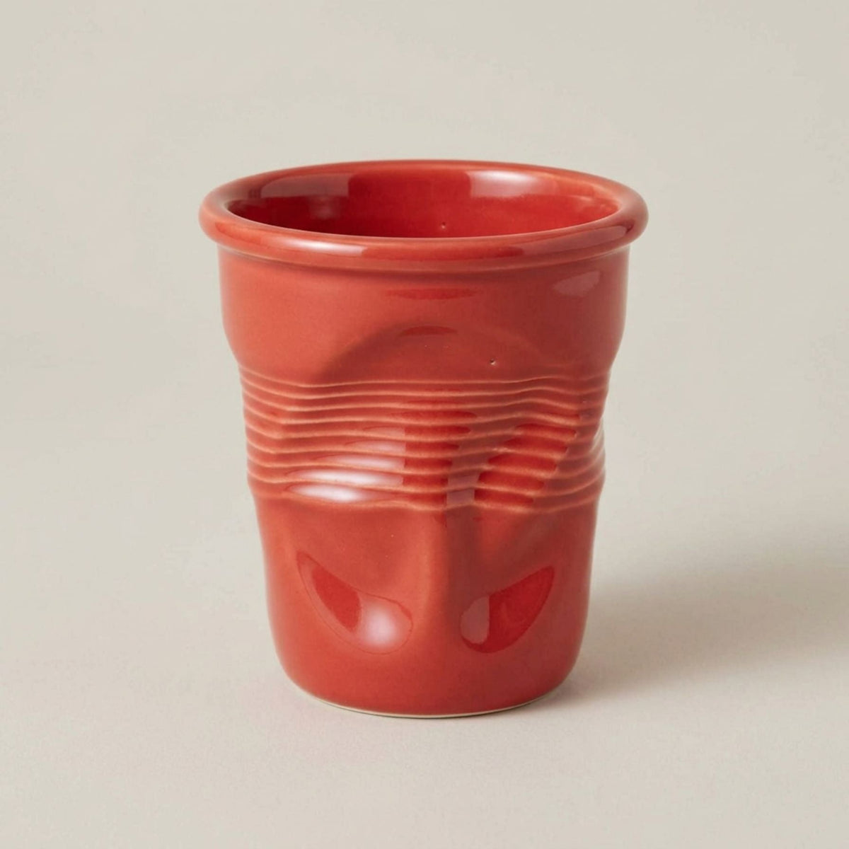 Textured ceramic mug with rounded rim and ribbed body