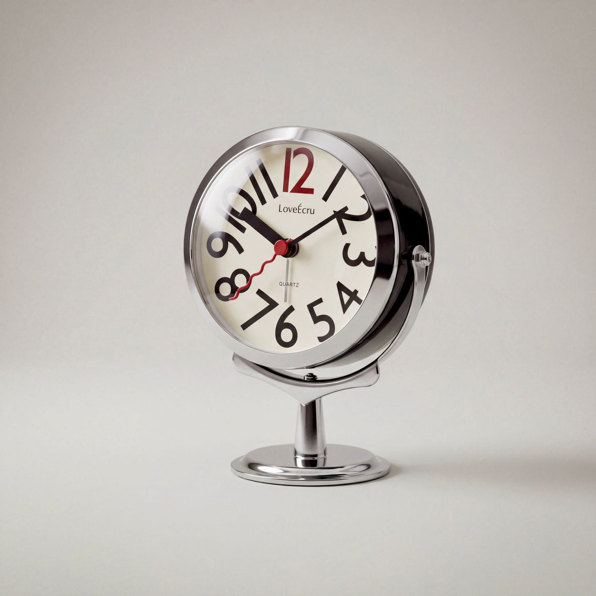 Freestanding analogue alarm clock with bold numbered dial and chrome effect stand