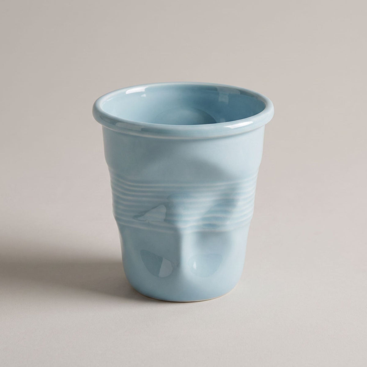 Textured ceramic mug with rounded rim and ribbed body