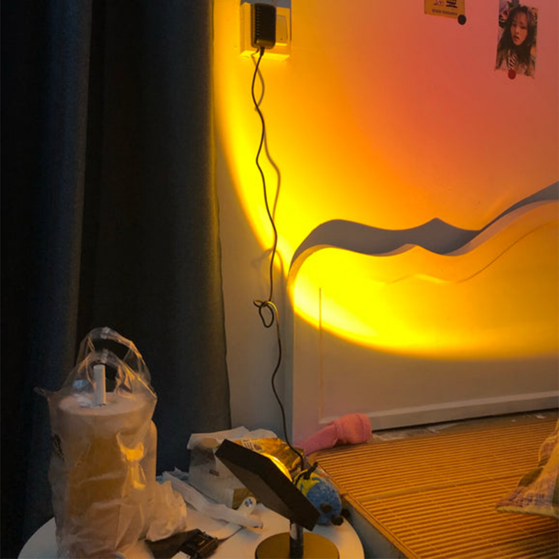 Circular glowing LED table lamp with dark stand and round base