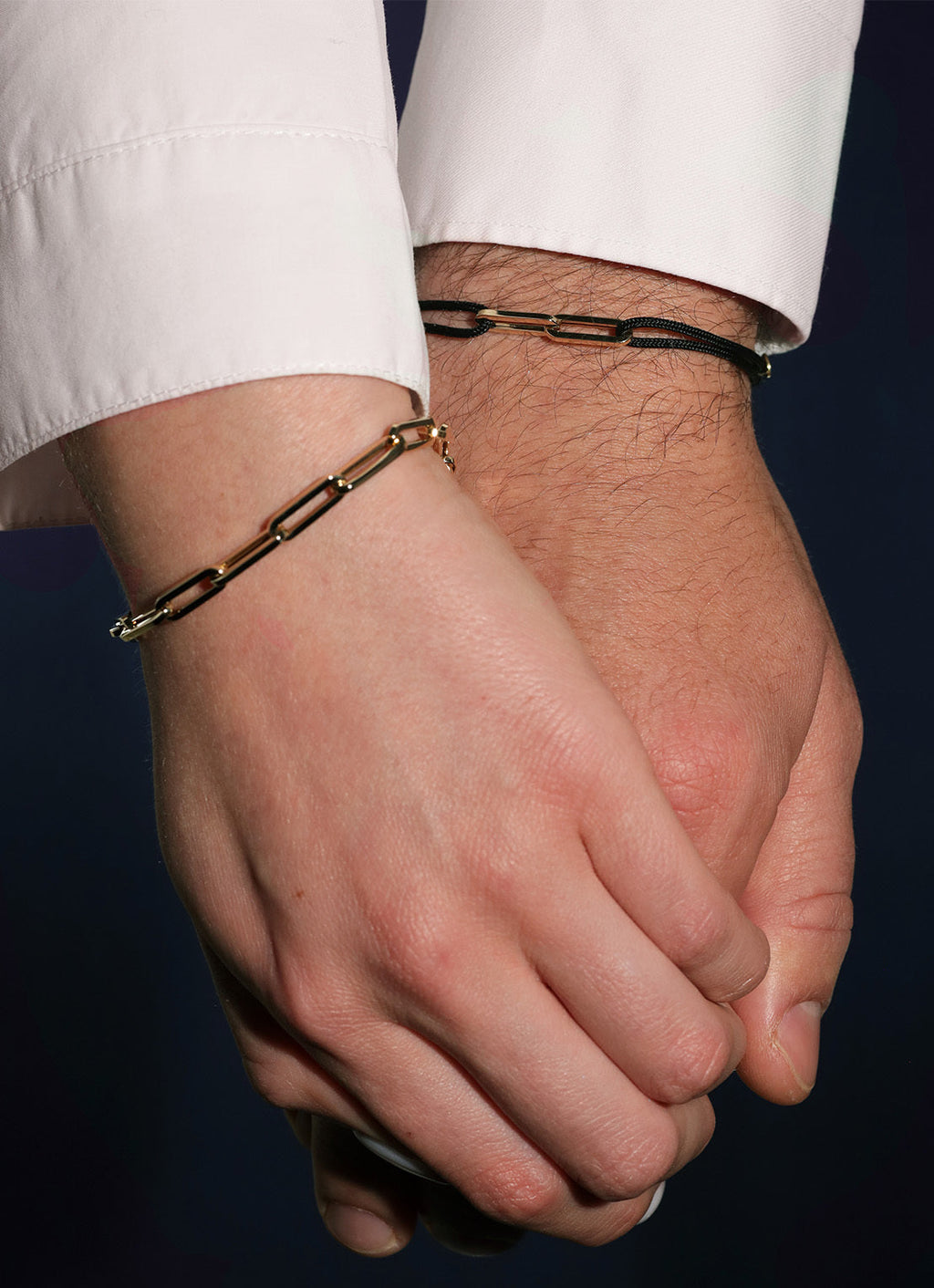 Black cord bracelet with a yellow-gold clasp