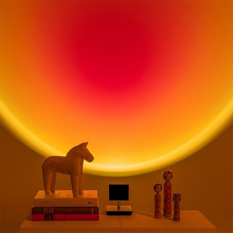 Circular glowing LED table lamp with dark stand and round base