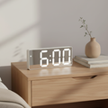 Digital alarm clock with LED time and temperature display on a bedside table
