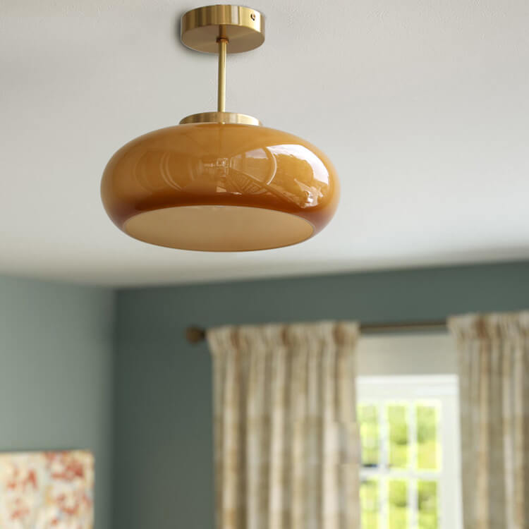 Semi-flush ceiling light with yellow rounded glass shade and brass finish