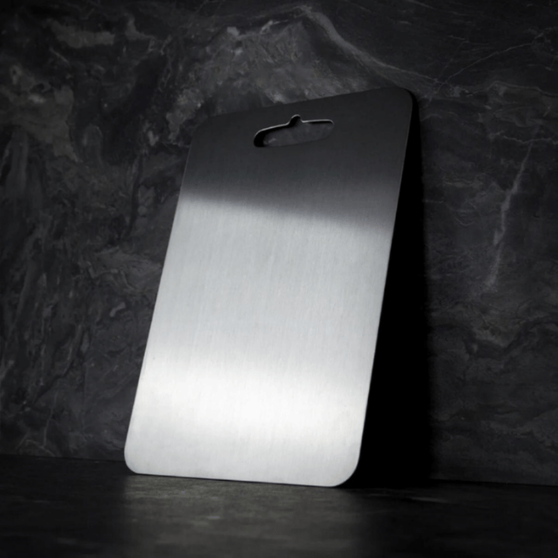 Three grey rectangular chopping boards with rounded corners and hanging holes