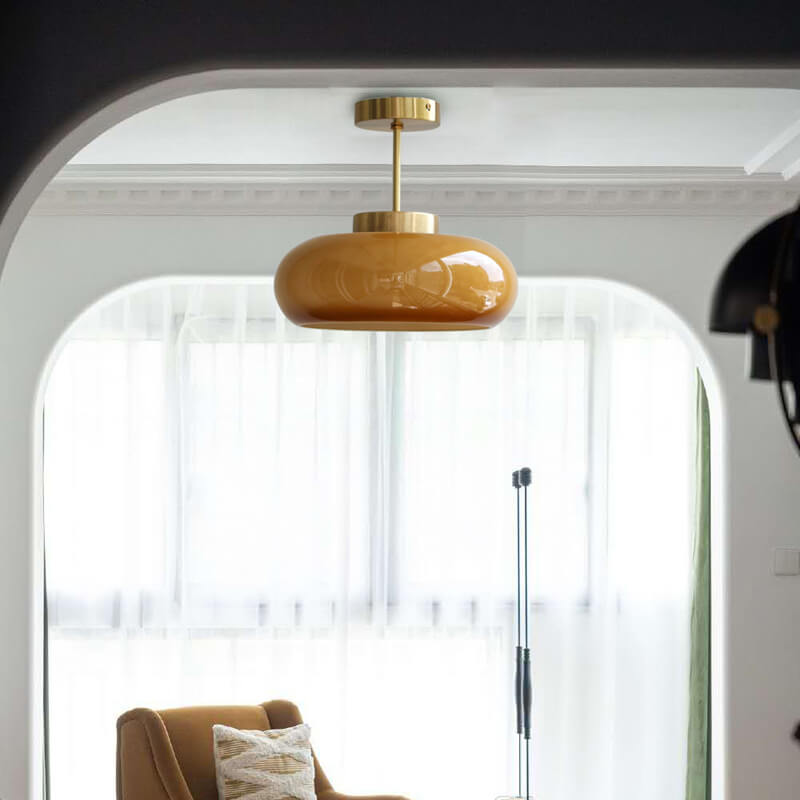 Semi-flush ceiling light with yellow rounded glass shade and brass finish