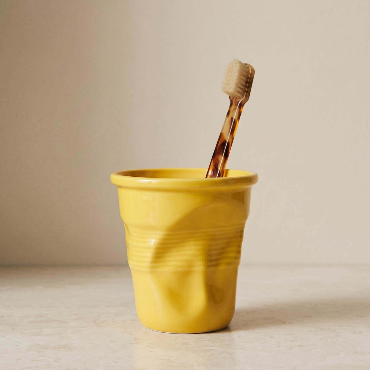 Textured ceramic mug with rounded rim and ribbed body