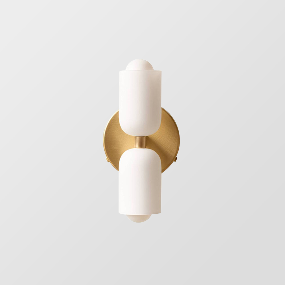Double head wall sconce with two cylindrical shades and round wall plate