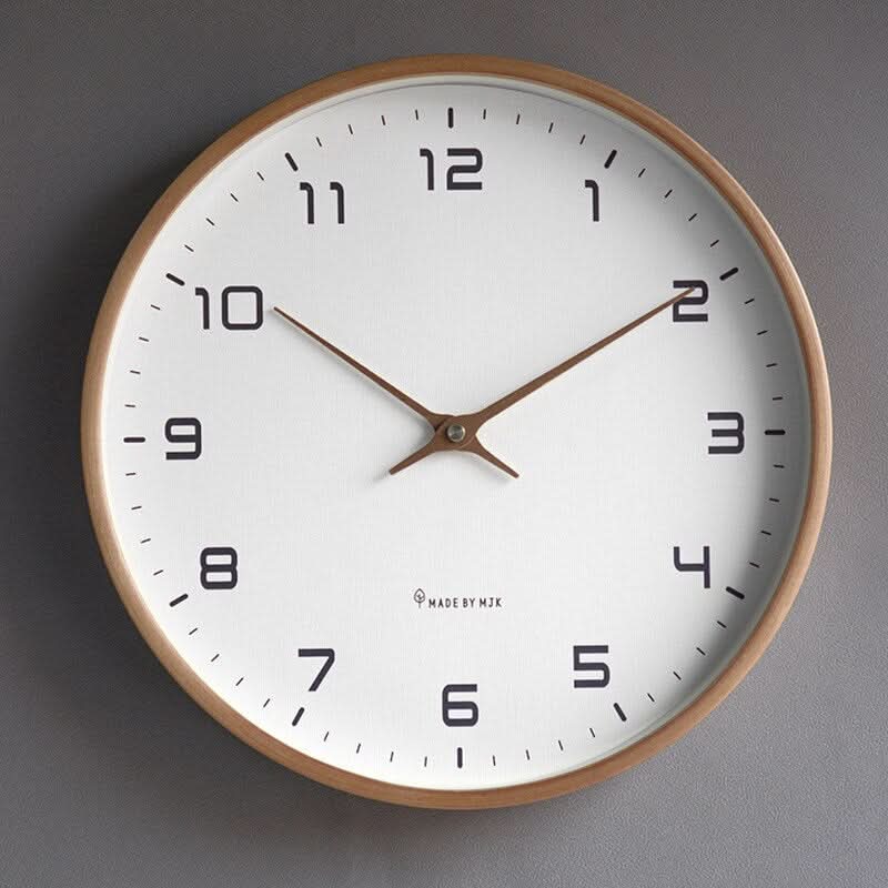 Round minimalist wall clock with large dark numerals and slim hands