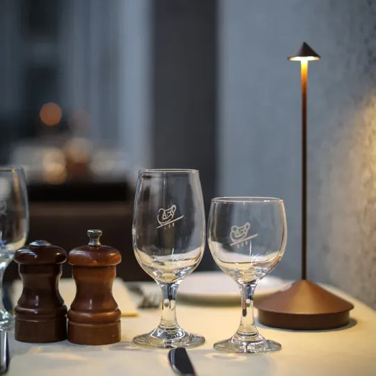 Wireless LED table lamp with a slim stem, conical shade and round base