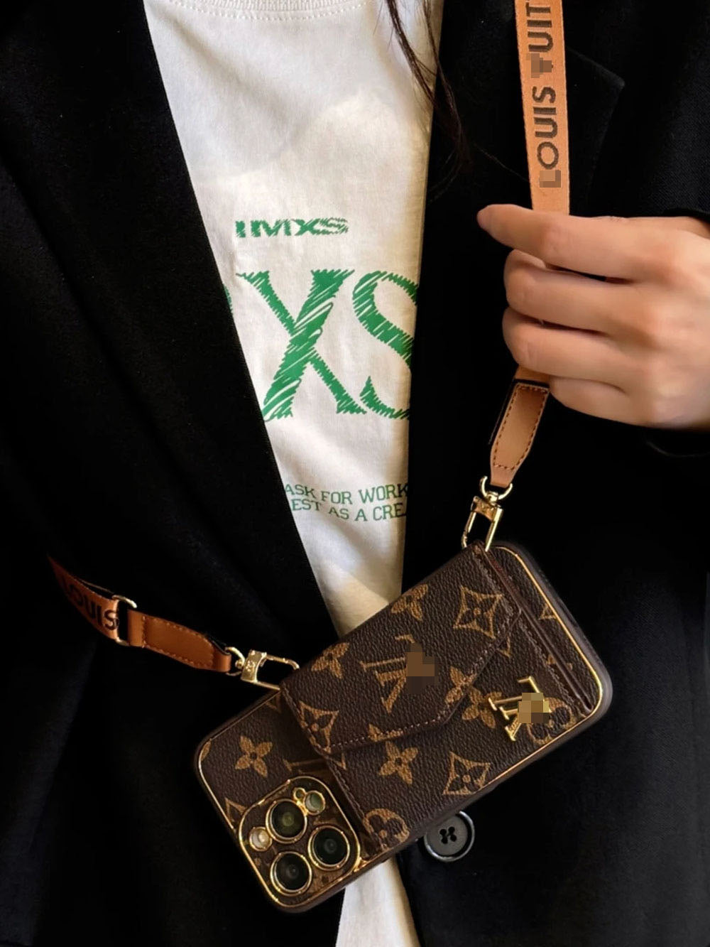 Brown patterned phone case with matching shoulder strap and gold-tone clips