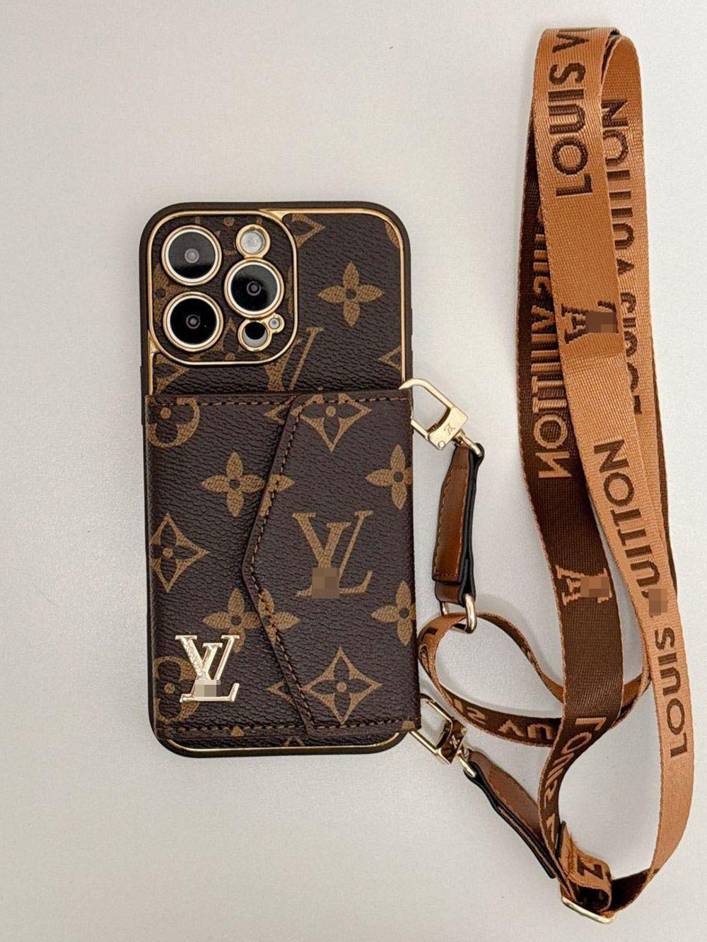 Brown patterned phone case with matching shoulder strap and gold-tone clips