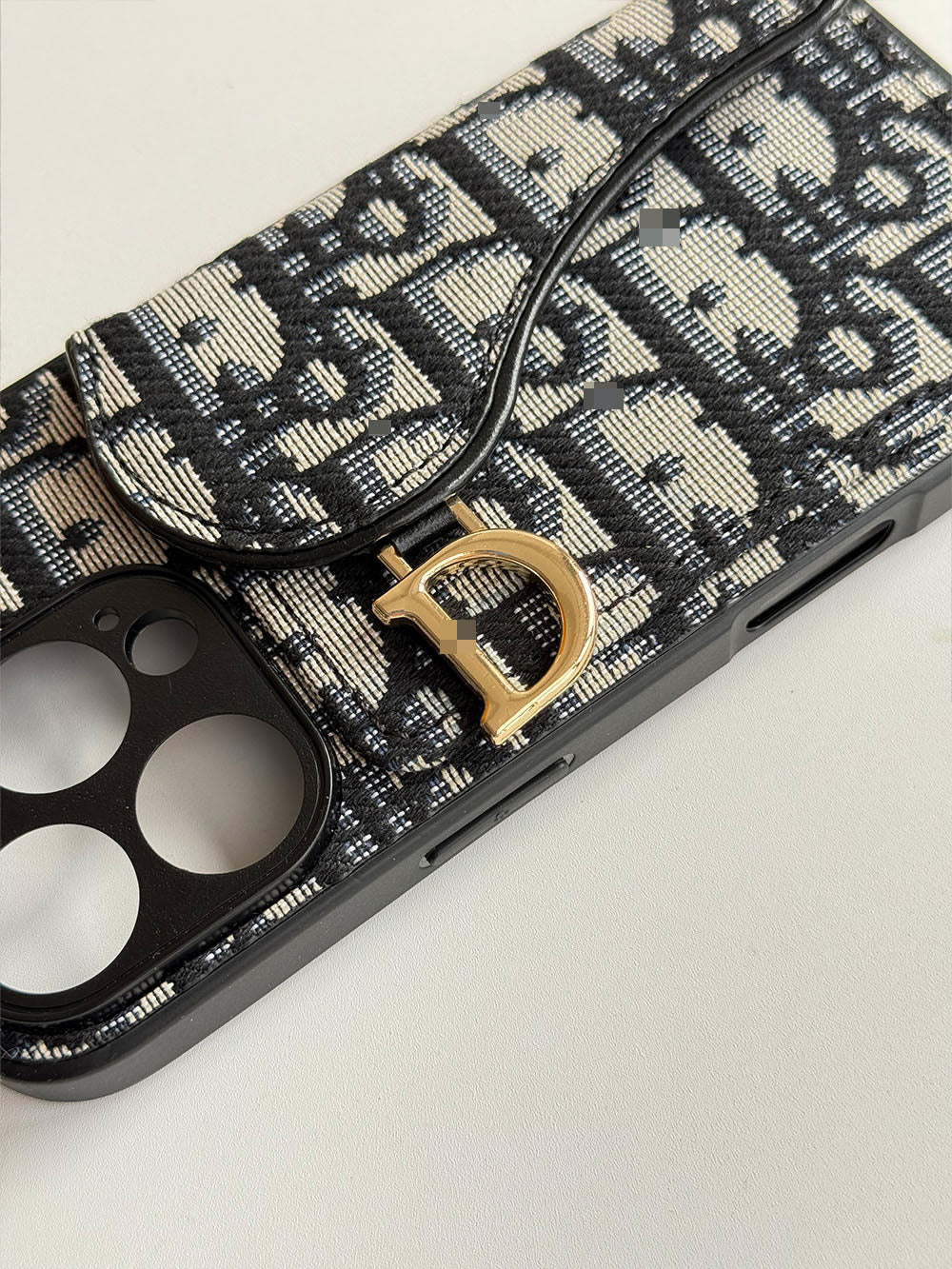 Black and cream geometric phone case with card-holder flap and gold-tone clip