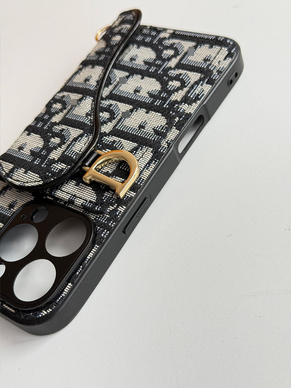 Black and cream geometric phone case with card-holder flap and gold-tone clip
