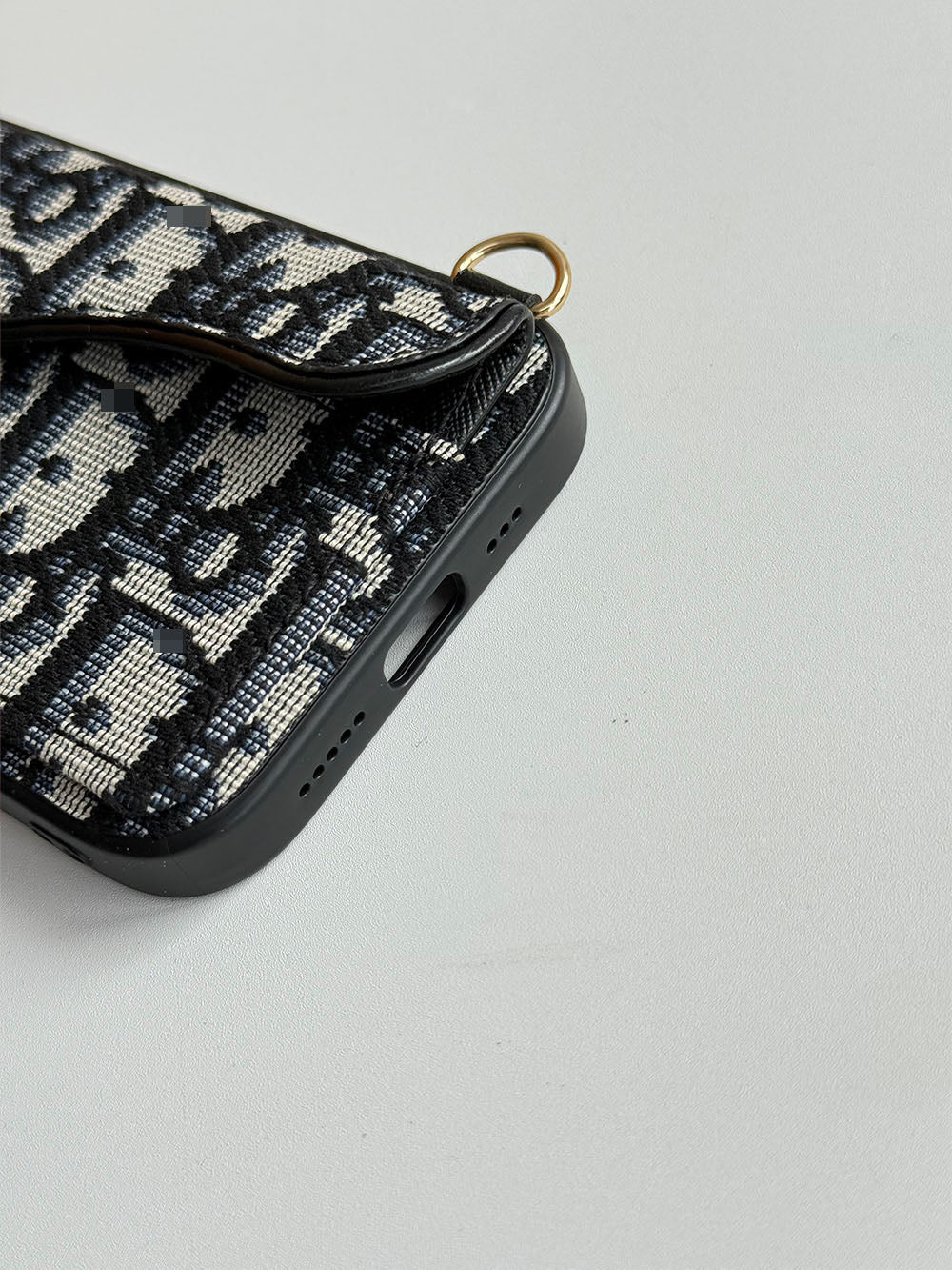 Black and cream geometric phone case with card-holder flap and gold-tone clip