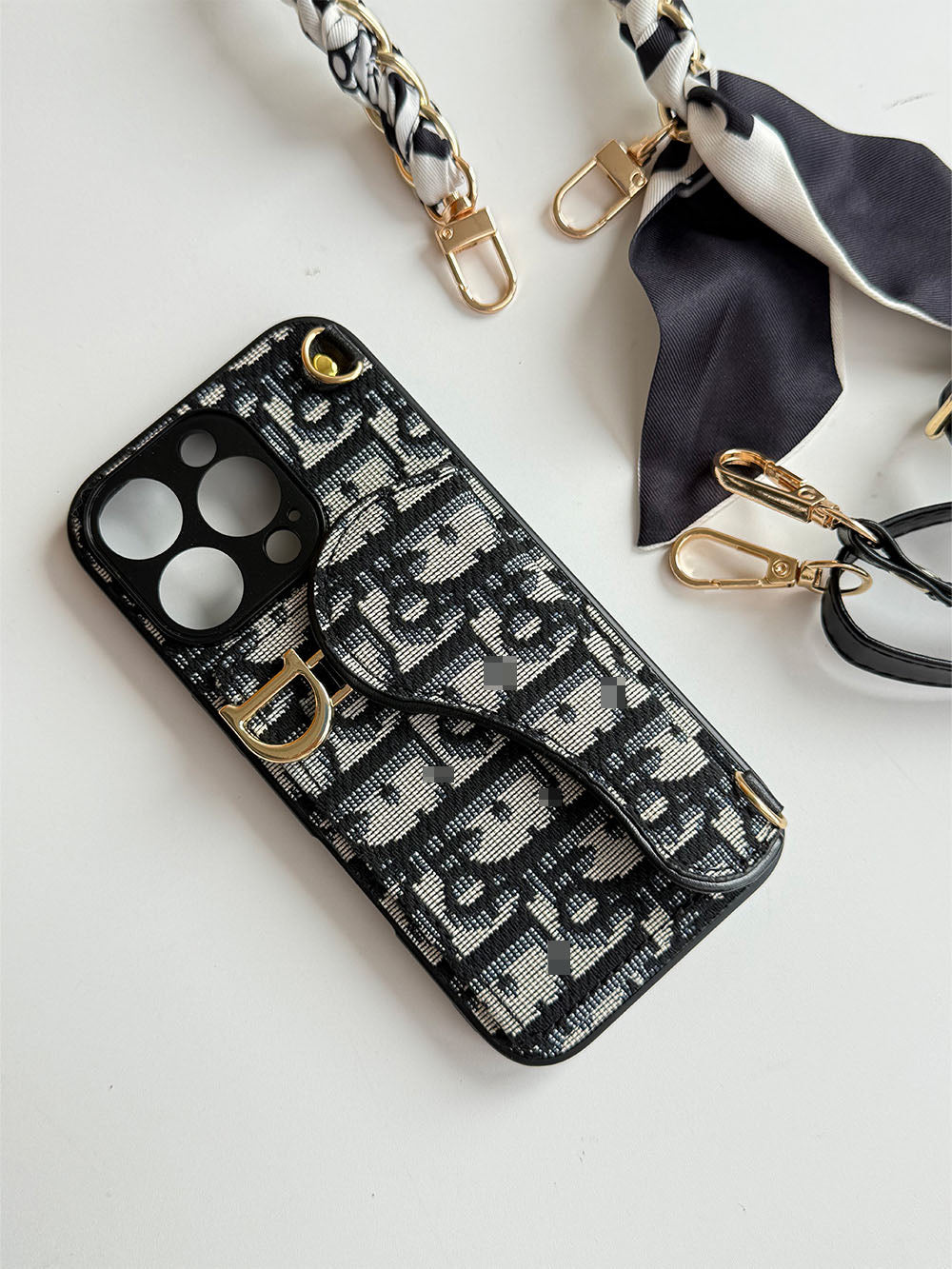 Black and cream geometric phone case with card-holder flap and gold-tone clip