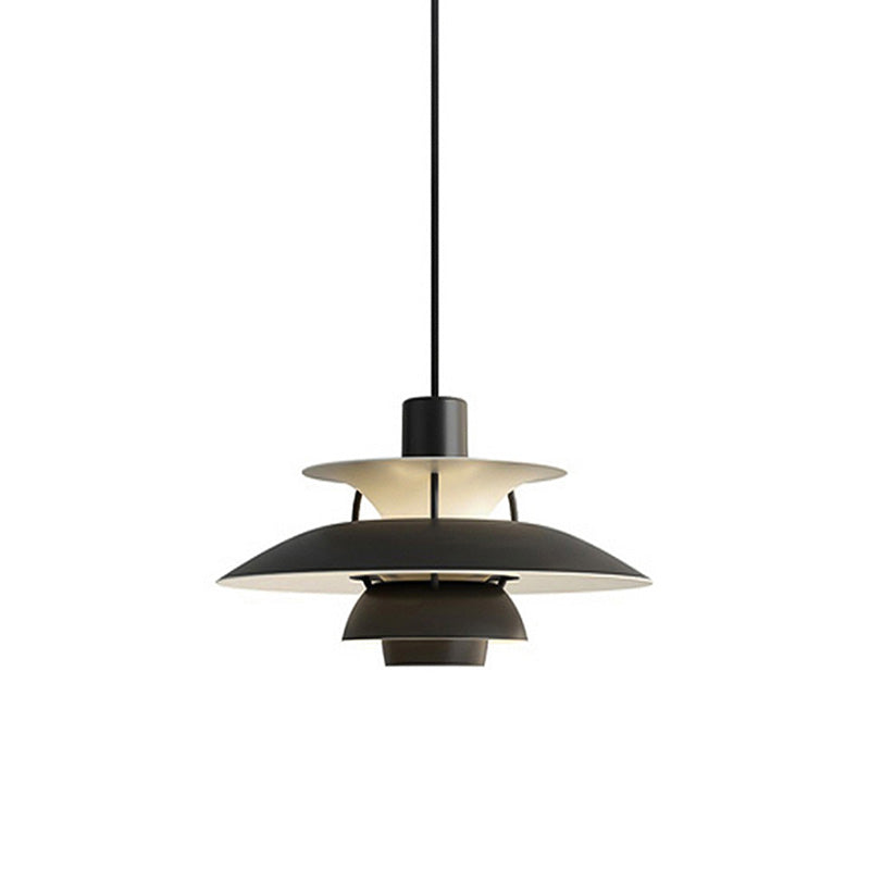 Layered pendant light with overlapping circular shades and hanging cord