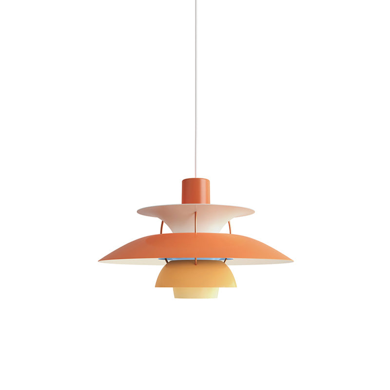 Layered pendant light with overlapping circular shades and hanging cord