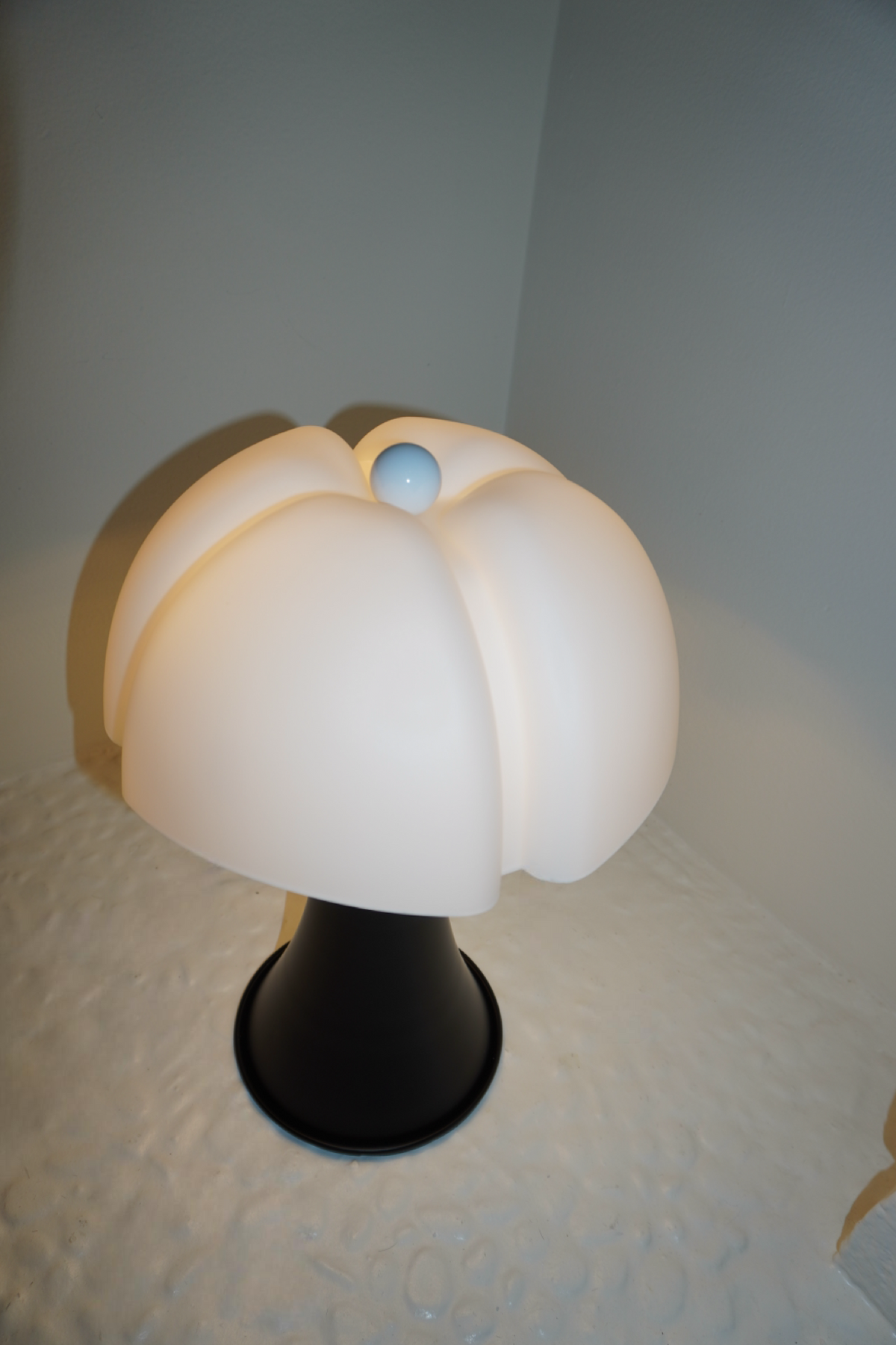 Black table lamp with sculpted soft white petal shade