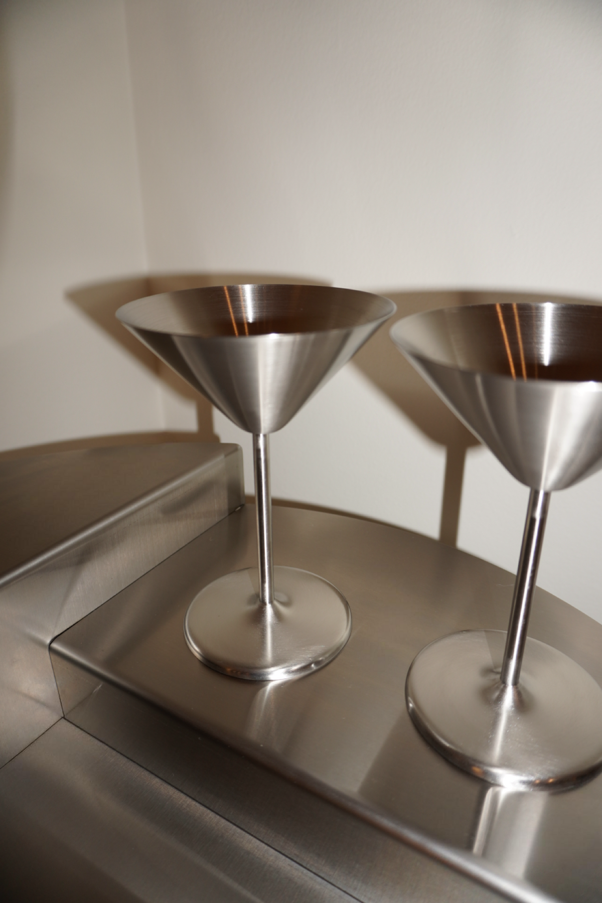 Pair of silver metallic stemmed martini glasses