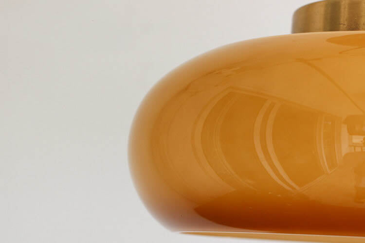 Semi-flush ceiling light with yellow rounded glass shade and brass finish