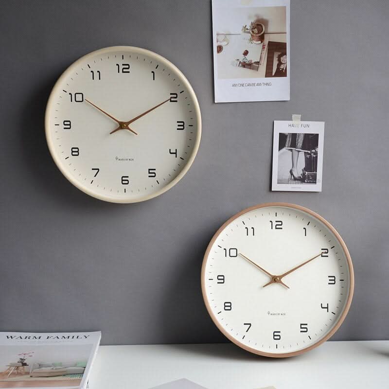 Round minimalist wall clock with large dark numerals and slim hands
