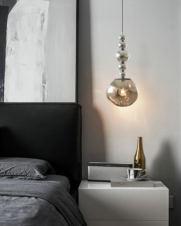 Hanging pendant light with smoked glass shade and silver spherical detailing