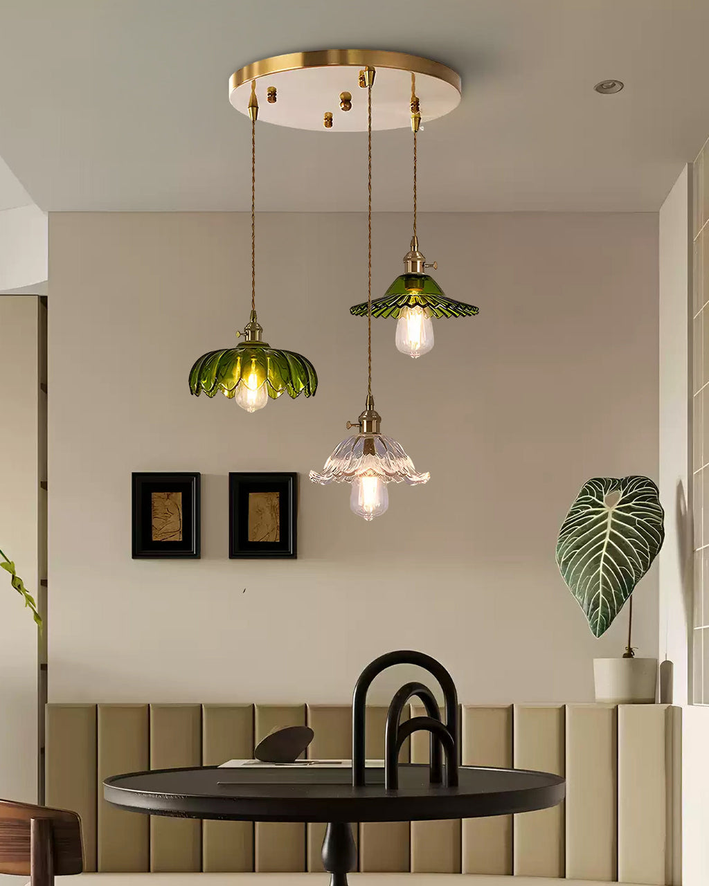 Three-shade pendant light with scalloped glass shades and brass-tone ceiling bar