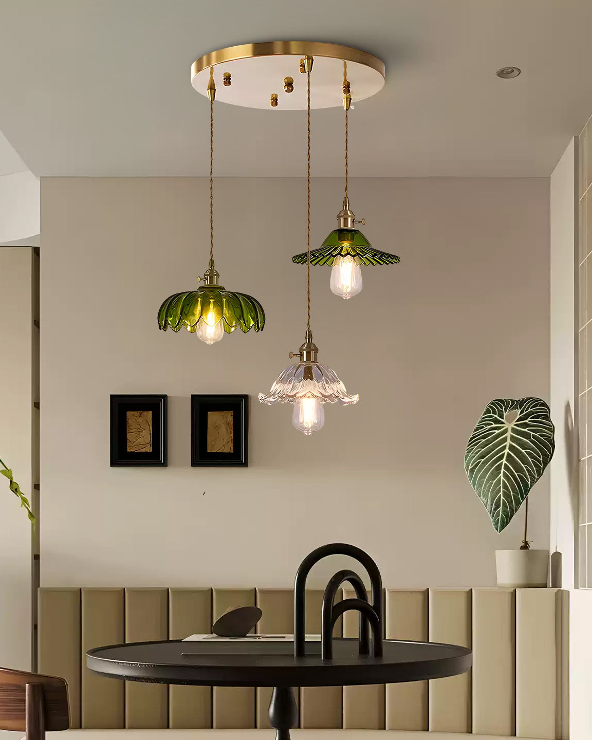 Three-shade pendant light with scalloped glass shades and brass-tone ceiling bar