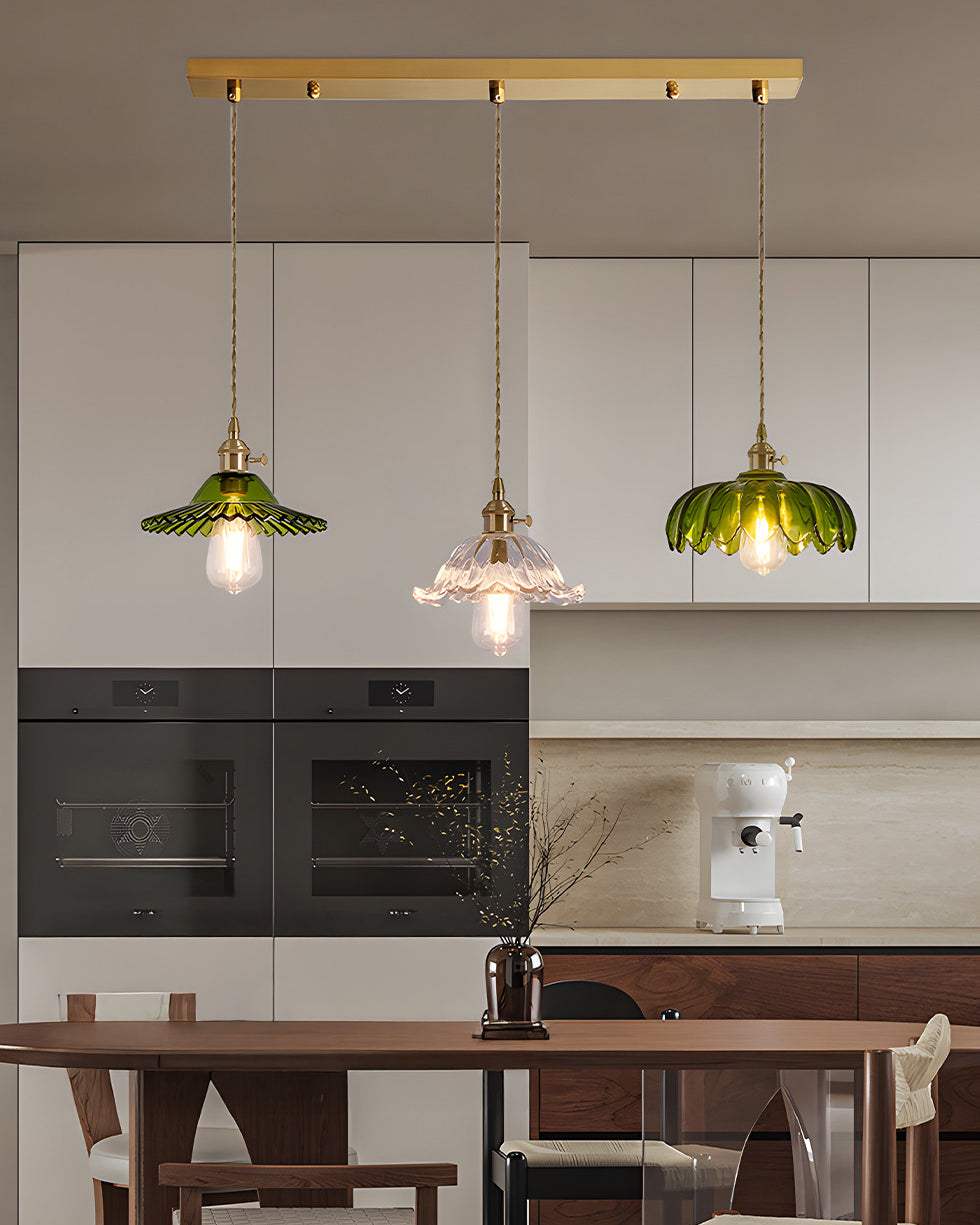 Three-shade pendant light with scalloped glass shades and brass-tone ceiling bar