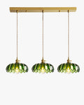 Three-shade pendant light with scalloped glass shades and brass-tone ceiling bar